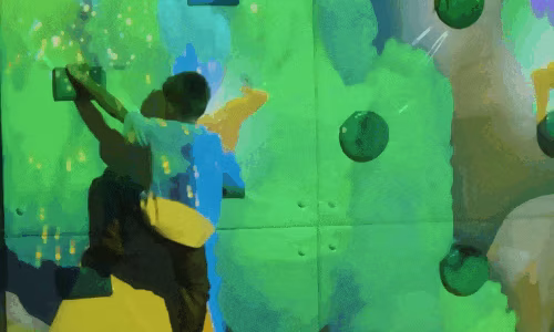 child-climbing-colorful-animated-wall